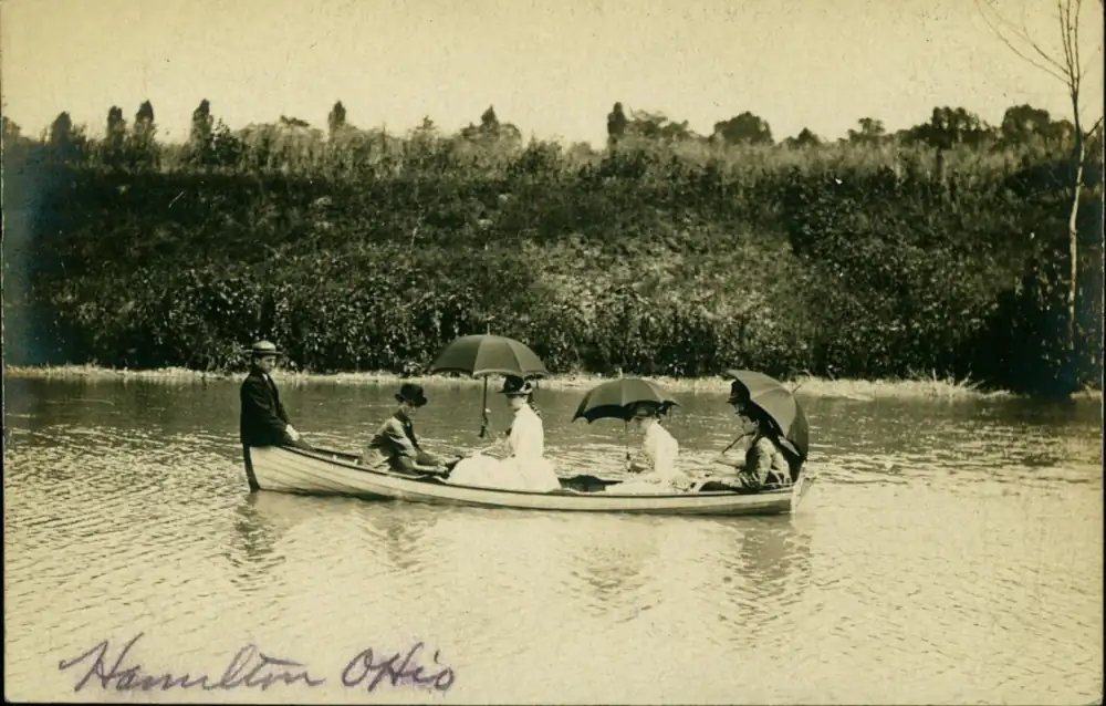 Postcard of a still canal channel lined with trees and buildings