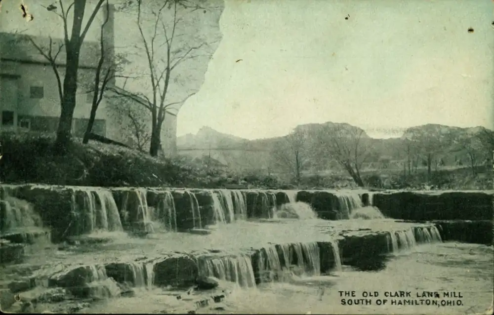 Postcard of the old Clark Lane mill building beside water