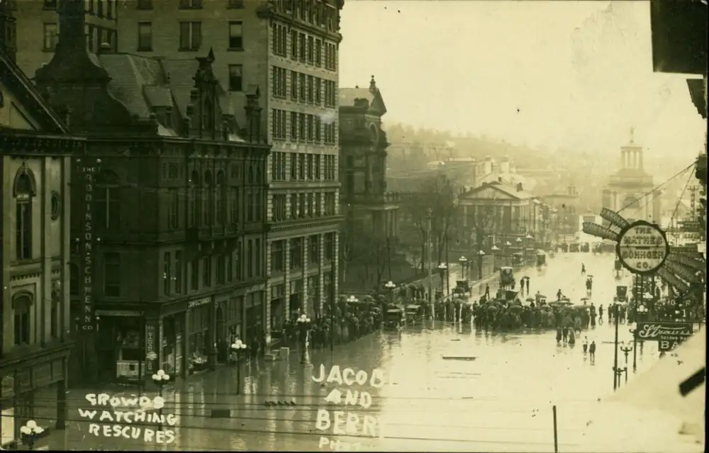 Photograph of crowds watching rescuers during the flood